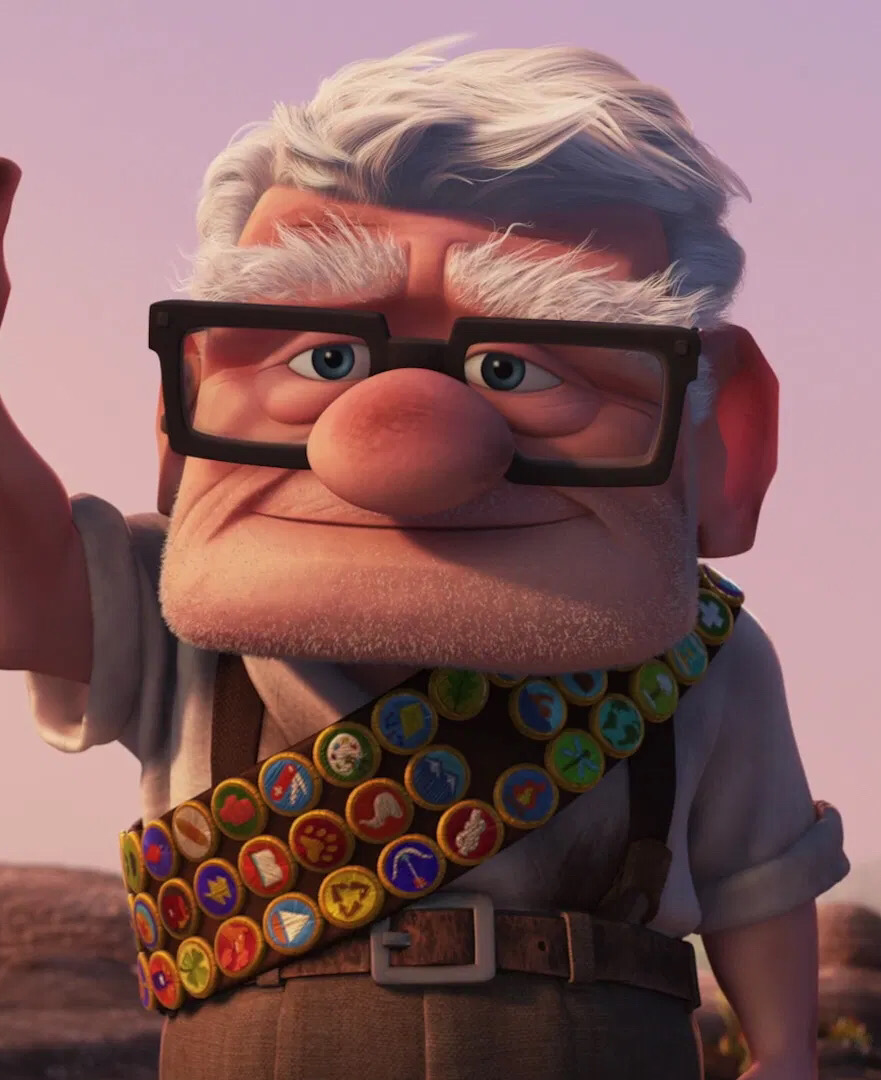 older man with glasses and badges